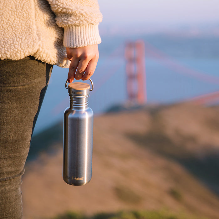 27oz-reflect-with-bamboo-cap-d5 K27SSLRF-BS-BAMBOO_reflect_bottle_bridge_lifestyle.jpg